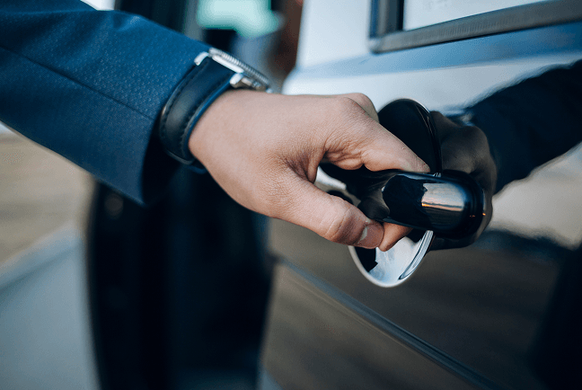Chauffeur opening a car door